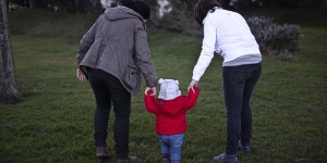 Same sex couple Olga Miranda (R) and Matilde Custodio (L) hold their daughter Carolina during a walk in the park in Lisbon on February 23, 2014. Matilde Custodio, 35 years old, call center operator and her girlfriend Olga Miranda, 31 years old, manager of a gourmet company have lived together for 10 years before deciding to have a child by artificial insemination. In Portugal the law allowing gay marriage, passed in January 2010, specifically excludes the right to adopt for homosexual couples making Olga's adoption of Carolina (14 months) impossible. AFP PHOTO/ PATRICIA DE MELO MOREIRA (Photo credit should read PATRICIA DE MELO MOREIRA/AFP/Getty Images)