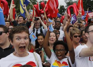 Gay rights supporters celebrate after the U.S. Supreme Court ruled that the U.S. Constitution provides same-sex couples the right to marry, outside the Supreme Court building in Washington, June 26, 2015. The court ruled 5-4 that the Constitution's guarantees of due process and equal protection under the law mean that states cannot ban same-sex marriages. REUTERS/Jim Bourg